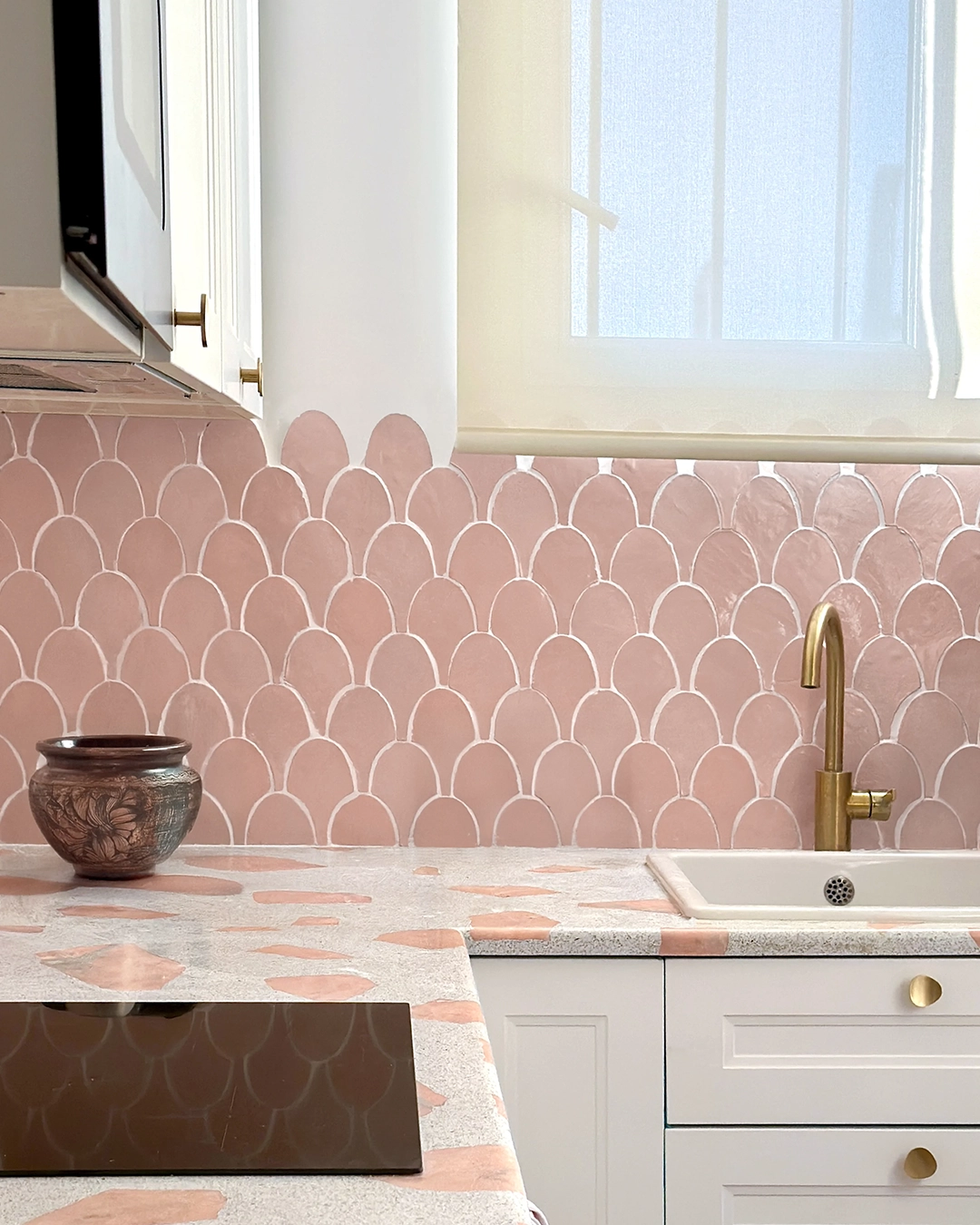Pink kitchen backsplash with zellige shell shaped tiles